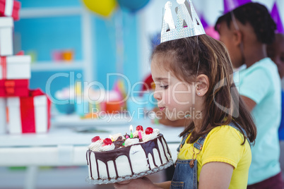 Smiling girl holding birthday cake