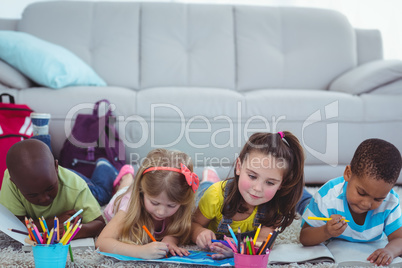 Smiling kids drawing pictures on paper