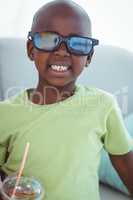 Smiling boy wearing 3d glasses for a movie
