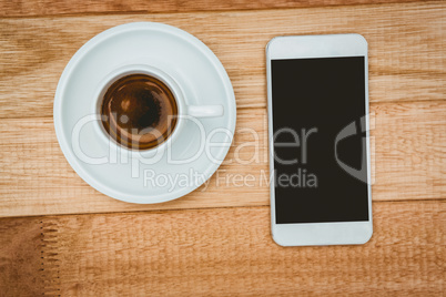 Above view of a coffee and a smartphone