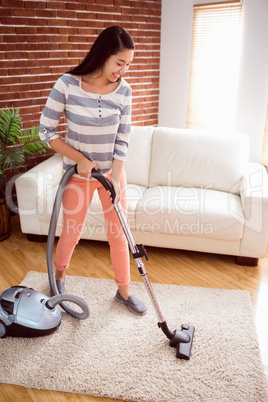 Woman hoovering the rug