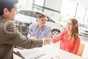 Smiling couple buying a new car