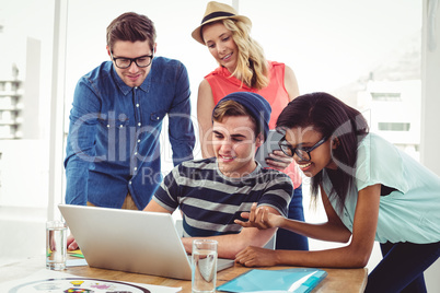 Creative business team working hard together on laptop