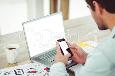 Creative businessman working on his smartphone