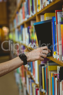 Student wearing a smart watch in library