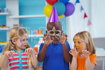 Smiling kids with faces painted