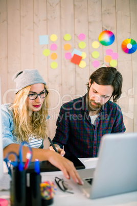 Creative team working at desk with laptop