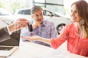 Smiling couple buying a new car