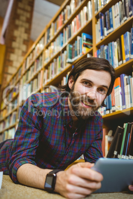 Student studying on floor in library wearing smart watch