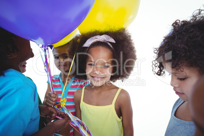 Group of kids together with balloons