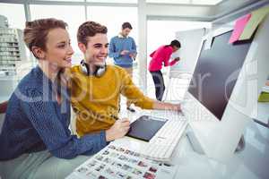 Graphic designer wearing headphones at desk