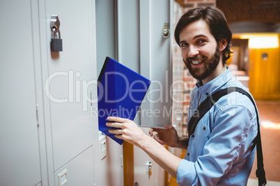 Hipster student smiling at camera in hallway