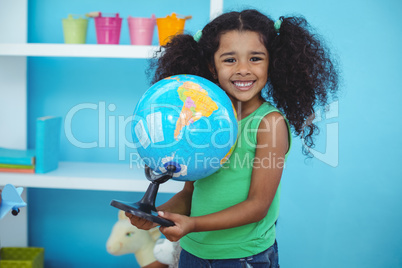 Small girl holding a globe of the world