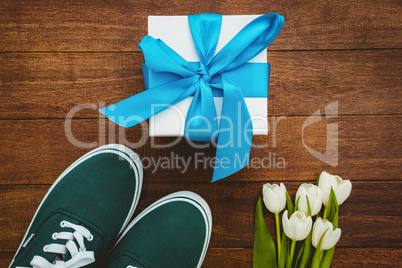 View of sneakers and blue gift