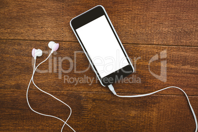 View of a black smartphone with white headphones