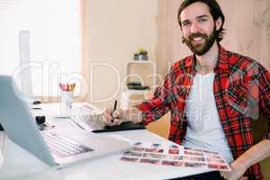 Handsome designer working at his desk