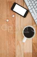 Black smartphone with cup of coffee