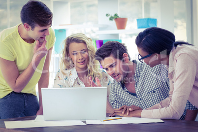 Creative business team working on a laptop together