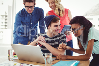 Creative business team working hard together on laptop