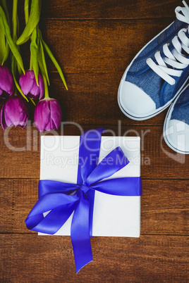 View of sneakers and blue gift