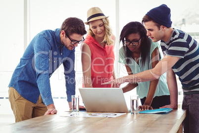 Creative business team working hard together on laptop