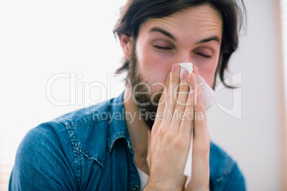 Sick man blowing his nose