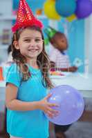 Happy kid holding a balloon
