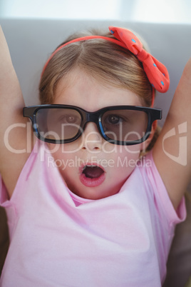 Close up of a girl wearing 3d glasses for a moive