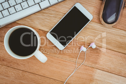 White smartphone with cup of coffee