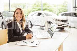 Happy businesswoman working at her desk