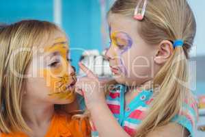 Smiling girls with their faces painted