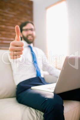 Businessman using laptop on the couch