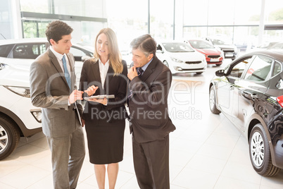 Sales team look at a clipboard