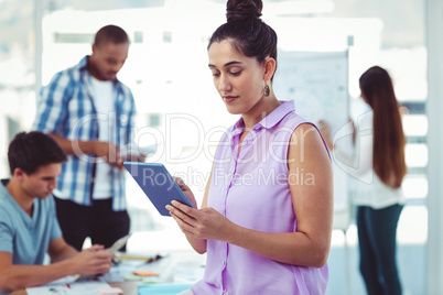 Young creative worker using tablet