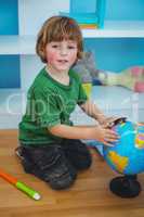 Boy using a globe of the world