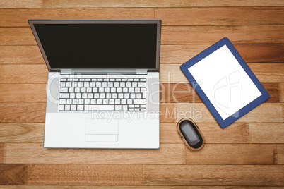 View of a grey laptop and a blue tablet