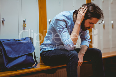 Hipster student feeling sad in hallway