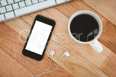 Black smartphone with cup of coffee