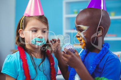 Smiling kids with icing on their faces