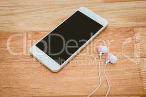 White smartphone with white headphones