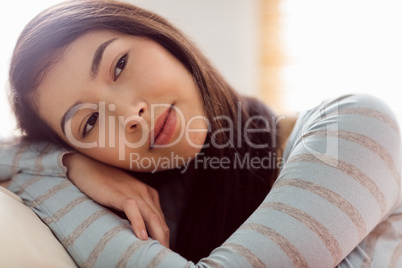 Asian woman relaxing on couch