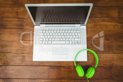 View of a grey laptop with a green headphone