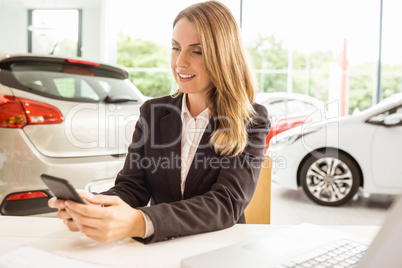 Smiling saleswoman having a phone call