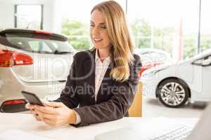 Smiling saleswoman having a phone call