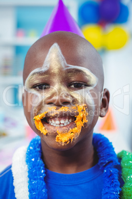 Smiling kid with icing on his face