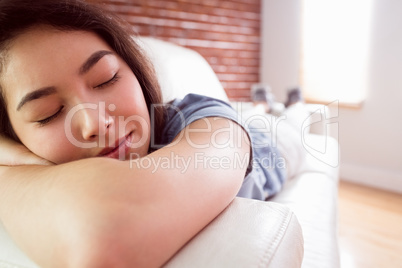 Asian woman napping on couch