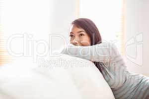 Asian woman relaxing on couch