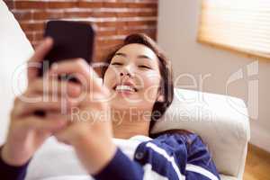 Asian woman laughing on the phone