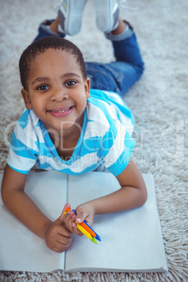 Smiling kids drawing pictures on paper