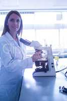 Scientist working with a microscope in laboratory